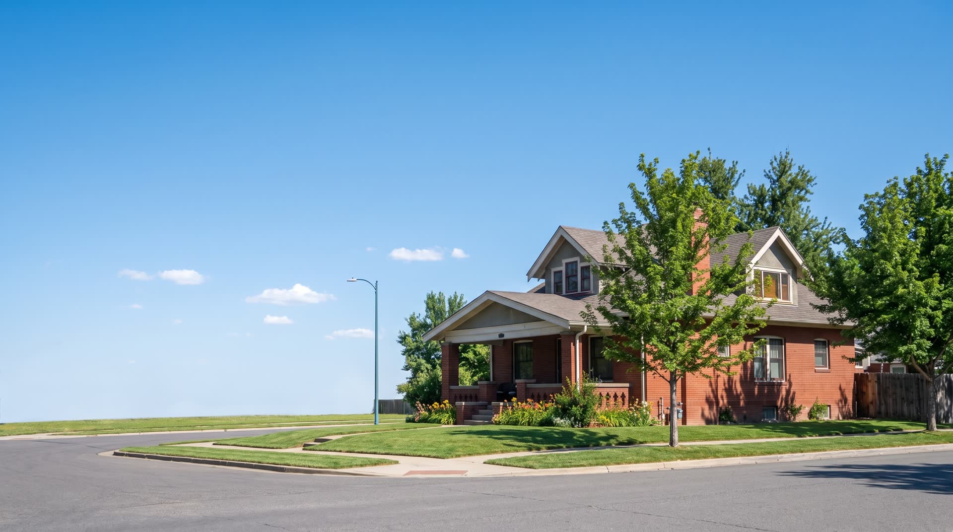 The same house on a bright July afternoon